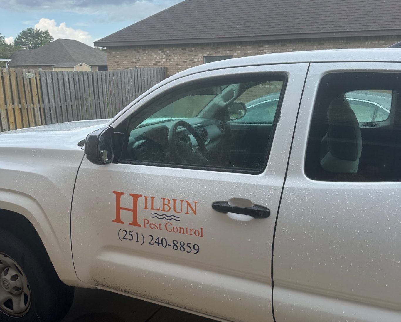 Hilbun Pest Services truck parked in a Dunmore subdivision driveway in Daphne Alabama preparing for a residential termite treatment