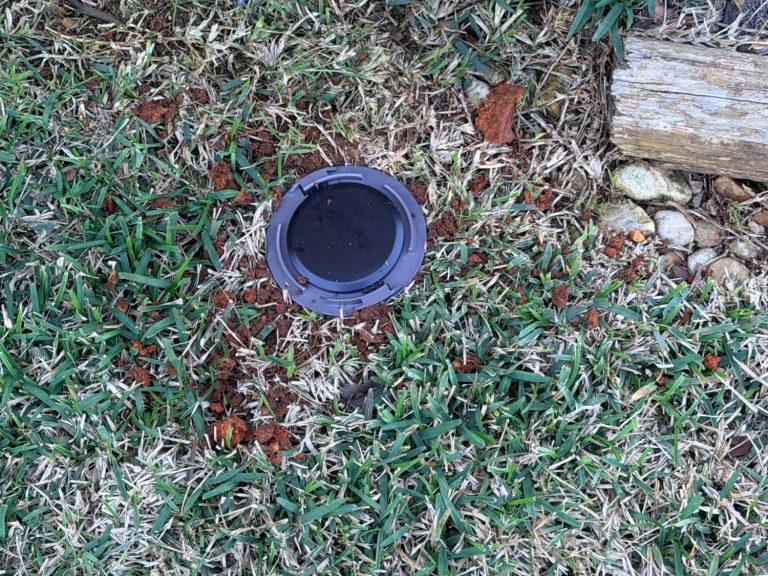 Termite Control in Foley AL - Hilbun Pest Control Hilbun Pest Control technician installing termite bait stations at a Foley, Alabama home.