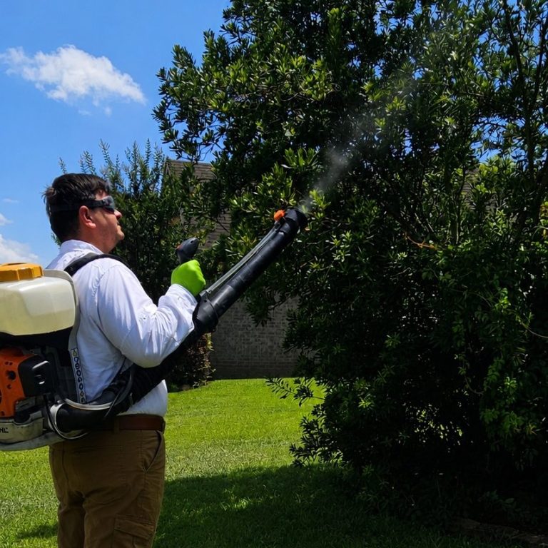 Traditional Mosquito Treatment in Fairhope, Alabama | Hilbun Pest Control Hilbun Pest Control technician applying a traditional mosquito treatment to landscape shrubs at a home in Fairhope, Alabama.