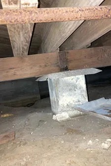 Crawlspace Access for Liquid Termite Treatment Crawlspace beneath a home showing support piers and accessible areas for liquid termite treatment applications.
