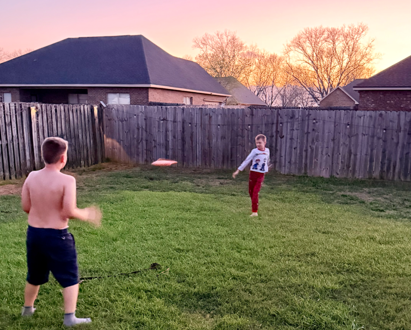 kids playing in backyard in Daphne AL without mosquitoes at sunset