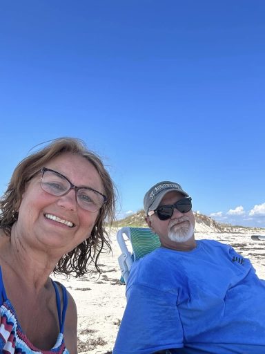 Gail and Steve Hilbun Relaxing on Orange Beach Gail and Steve Hilbun sitting together on Orange Beach, Alabama, enjoying a sunny day by the Gulf Coast.