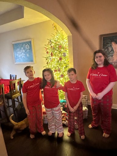 Hilbun Family Christmas Morning Tradition The Hilbun children wearing matching Christmas pajamas and posing beside the family Christmas tree.