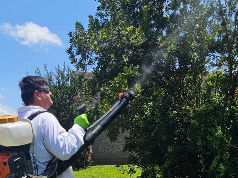 Mosquito Control in Foley AL - Hilbun Pest Control Hilbun Pest Control technician applying mosquito treatment around shrubs in Foley, Alabama.
