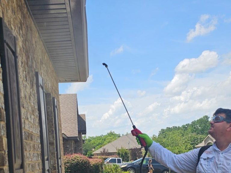 Pest Control in Foley AL - Hilbun Pest Control Hilbun Pest Control technician treating a home's exterior perimeter in Foley, Alabama.