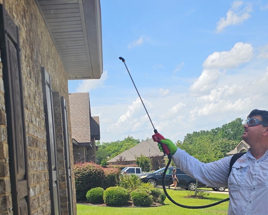 Professional Pest Control Service in Bay Minette, AL | Hilbun Pest Control Hilbun Pest Control technician performing an exterior perimeter treatment at a residential property in Bay Minette, AL.