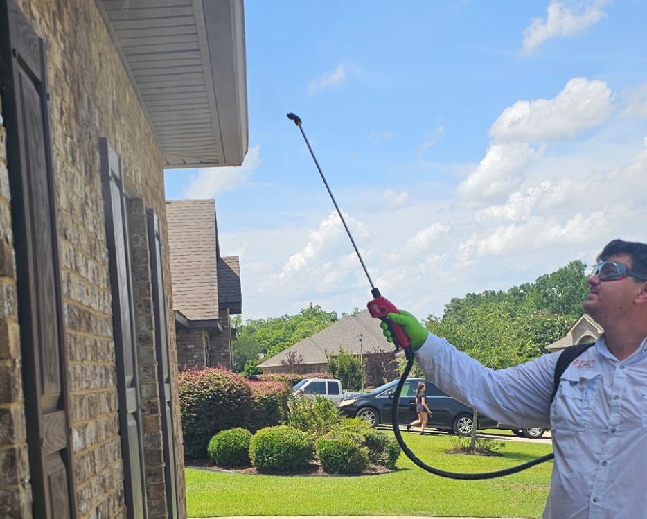 Pest Control Services in Fairhope, Alabama | Hilbun Pest Control Hilbun Pest Control technician applying an exterior perimeter pest treatment around a home in Fairhope, Alabama.
