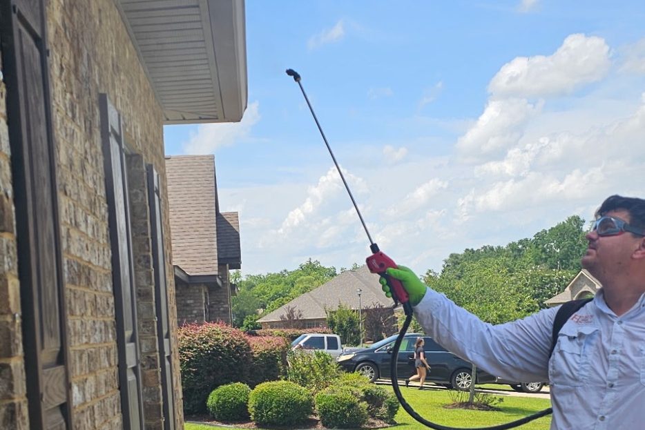 Residential Pest Control Services in Fairhope, Alabama | Hilbun Pest Control Hilbun Pest Control technician applying a professional exterior perimeter treatment around a home in Fairhope, Alabama.