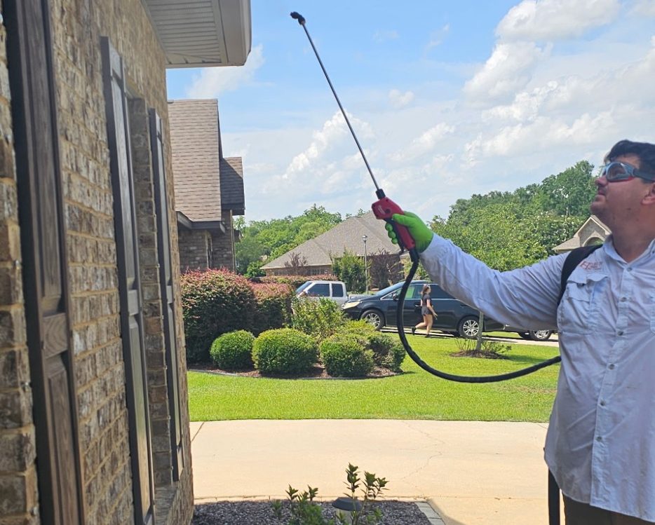 Pest Control in Foley AL | Hilbun Pest Control Hilbun Pest Control technician performing an exterior perimeter treatment in Foley, Alabama.