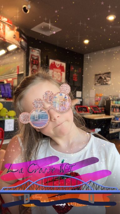 Sarina Showing Off Her Playful Personality Sarina wearing glittery sunglasses and smiling inside a restaurant in La Crosse, Wisconsin.