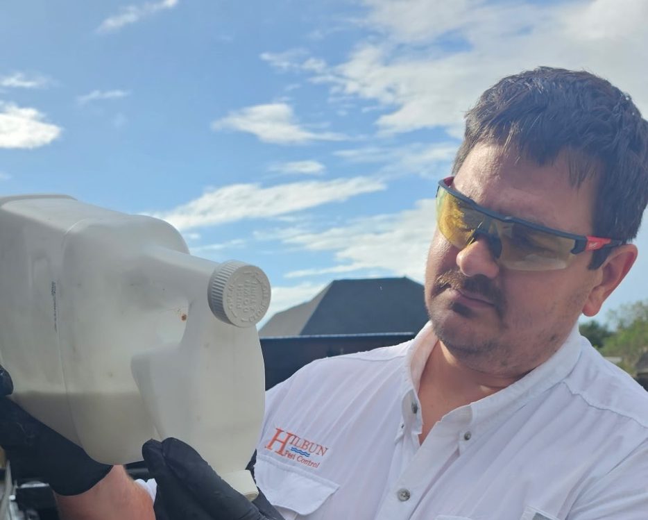 Pest control technician in Daphne AL mixing Bifen insecticide for residential pest control treatment